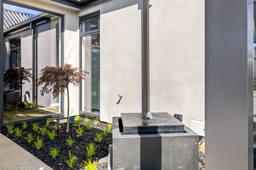 Hallmark Homes Oakbridge modern courtyard with water feature and contemporary landscaping - Christchurch luxury home builder