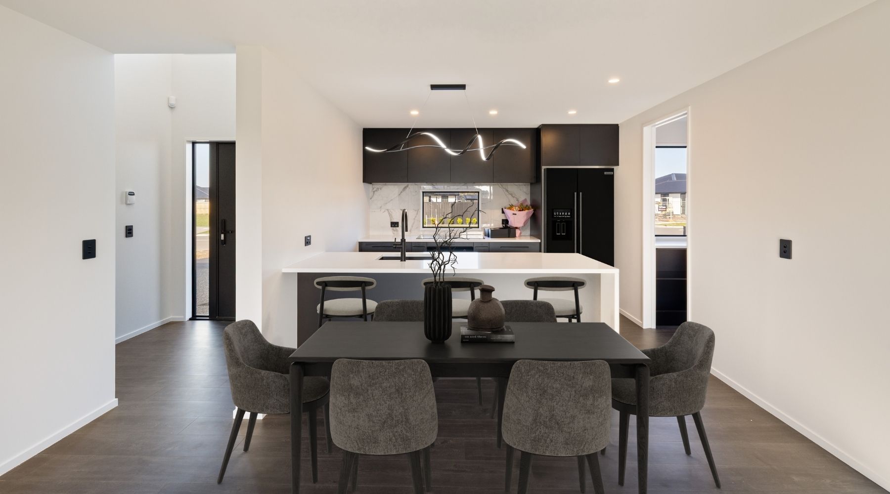 Modern kitchen area with black and white features