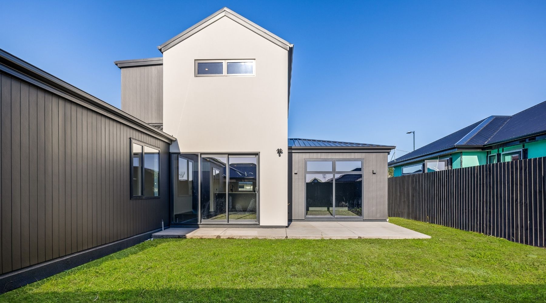 Rear exterior of a modern Hallmark Homes design and build, located in Christchurch and finished with striking dark tones.