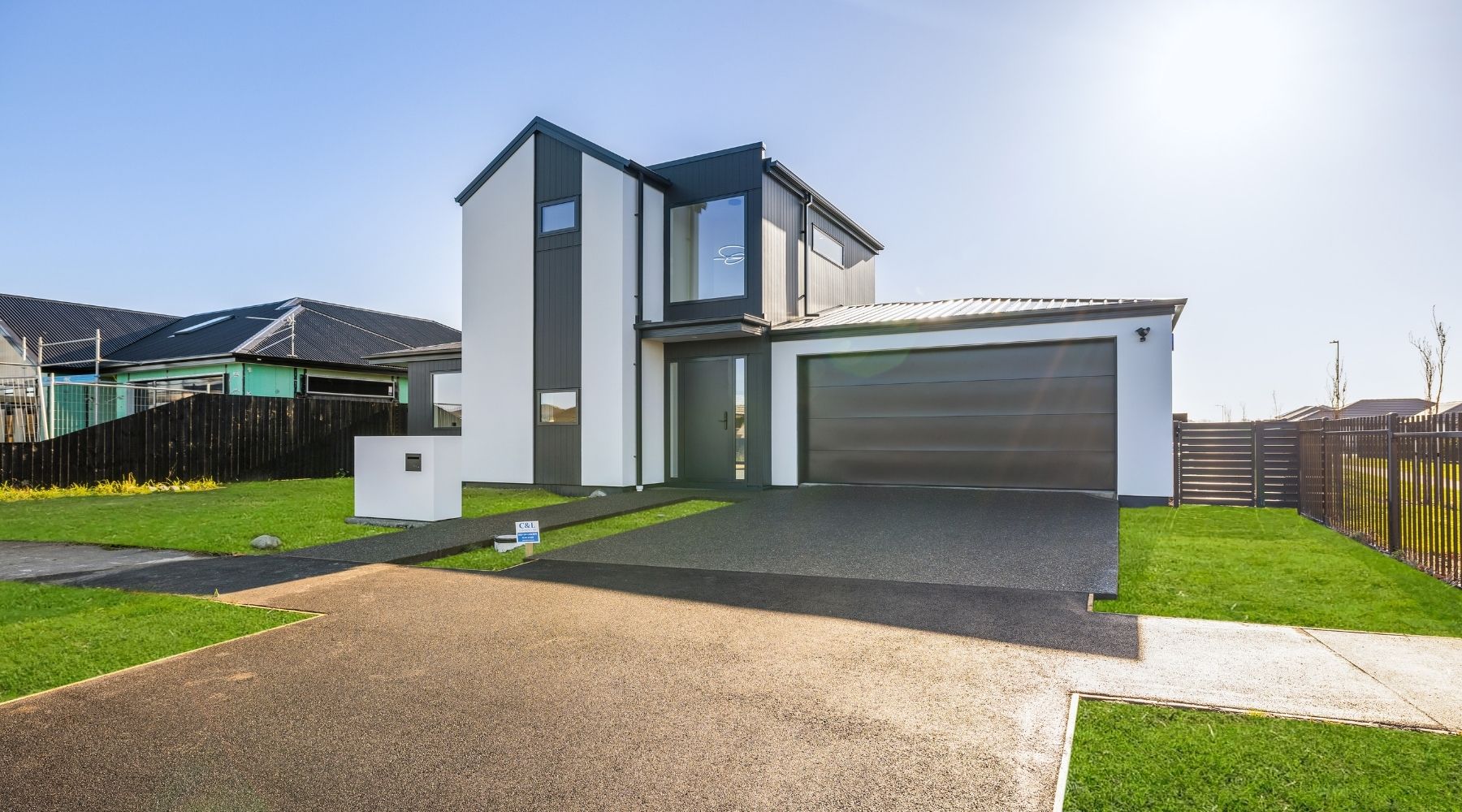 Two-storey Hallmark Homes build with a striking black and white facade, showcasing custom design and build in Canterbury.