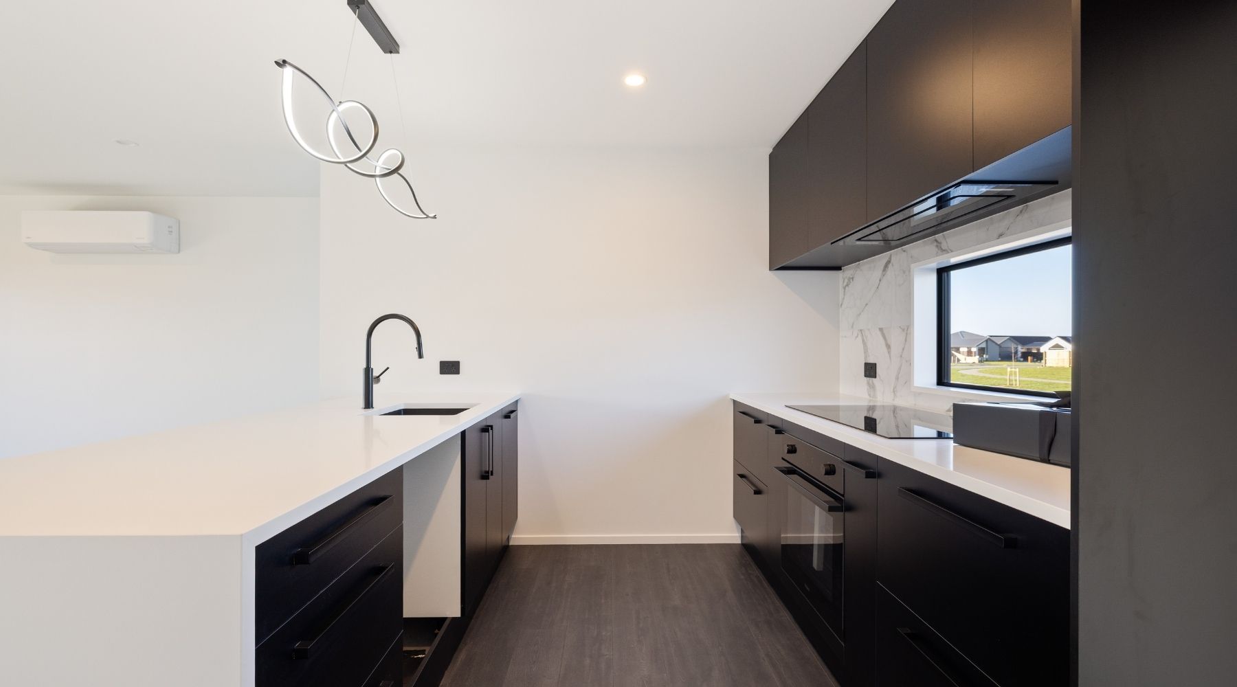 Black and white kitchen in a Christchurch home by Hallmark Homes — clean, modern design and build aesthetic.