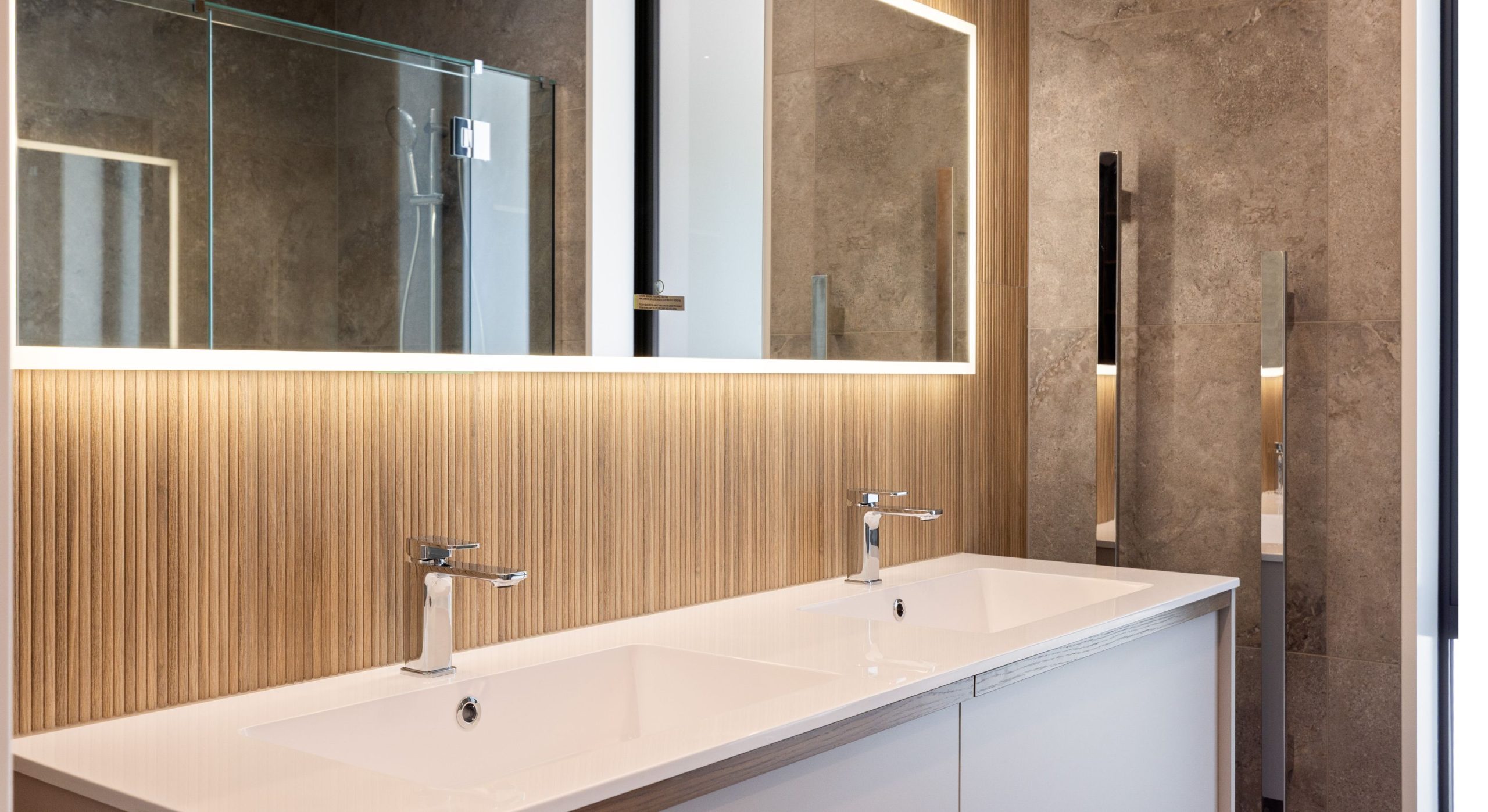 modern bathroom with double vanity backlit mirror