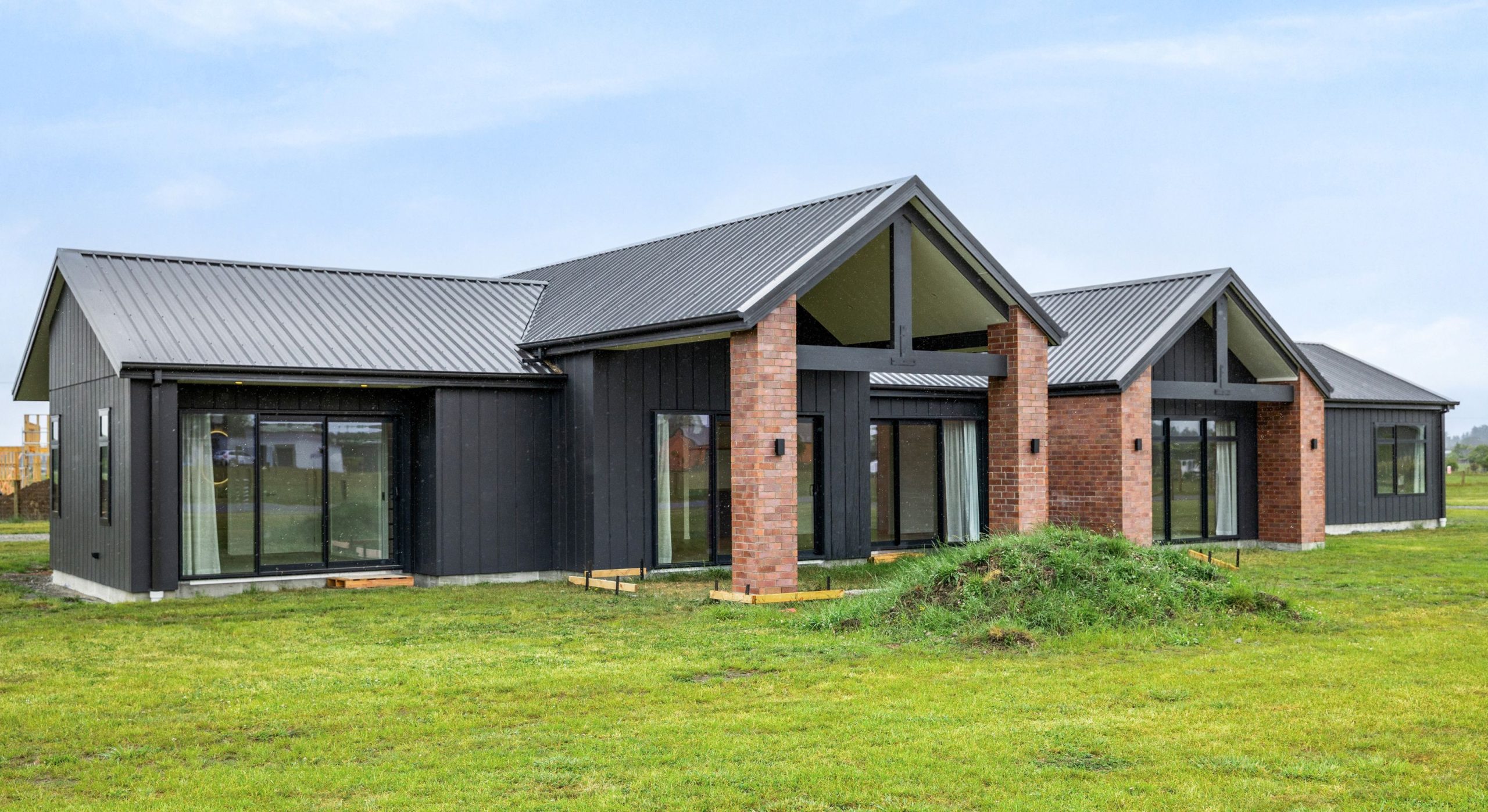 farmhouse plan with a red brick as the feature