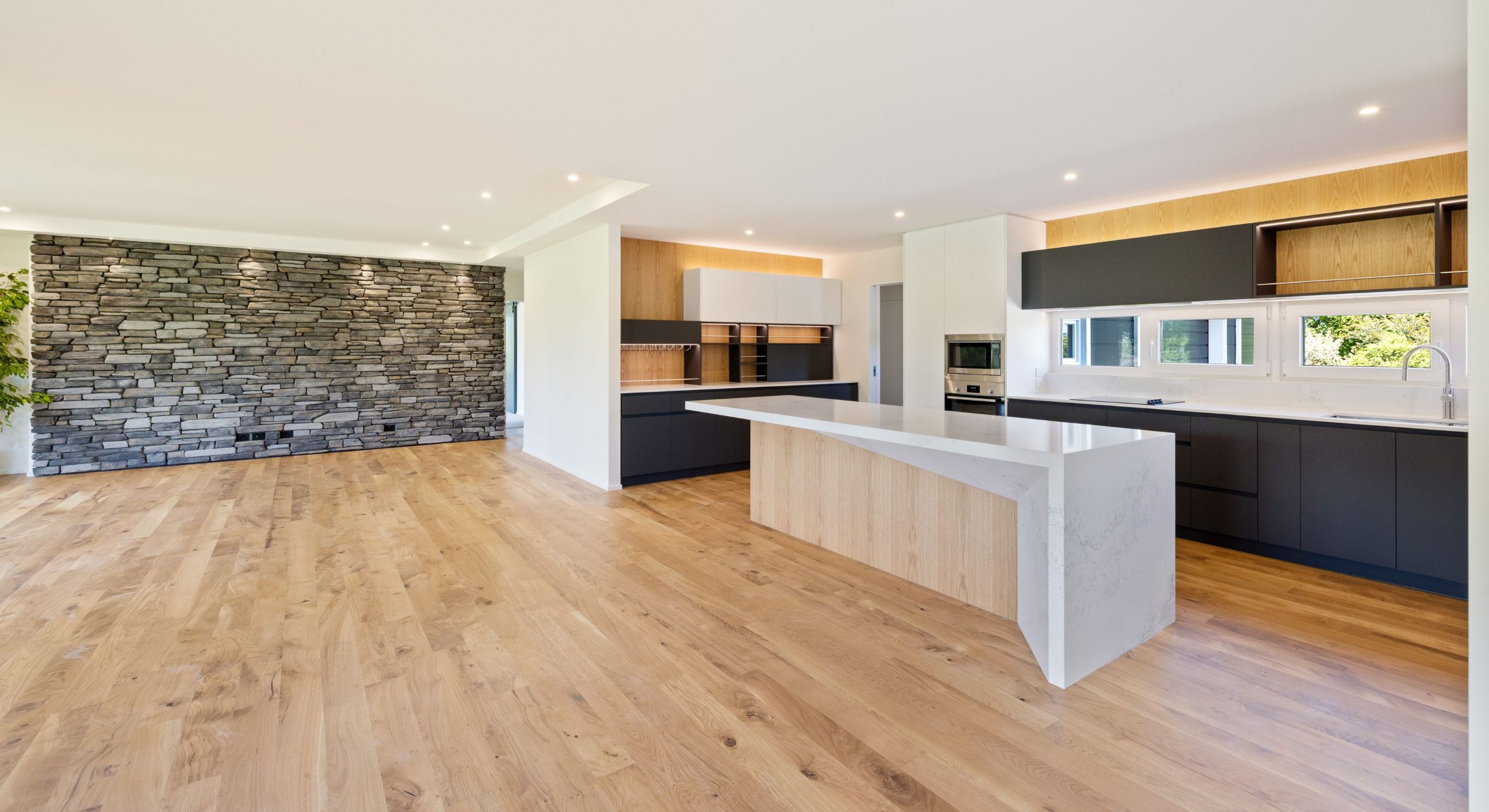 open plan with feature schist wall in the living room