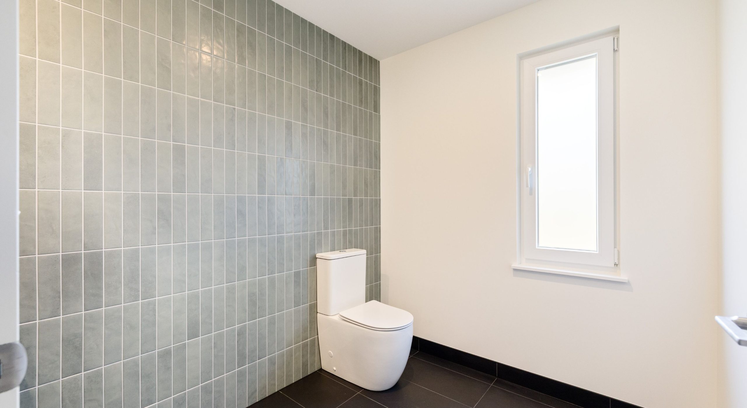 green tiled separate toilet with