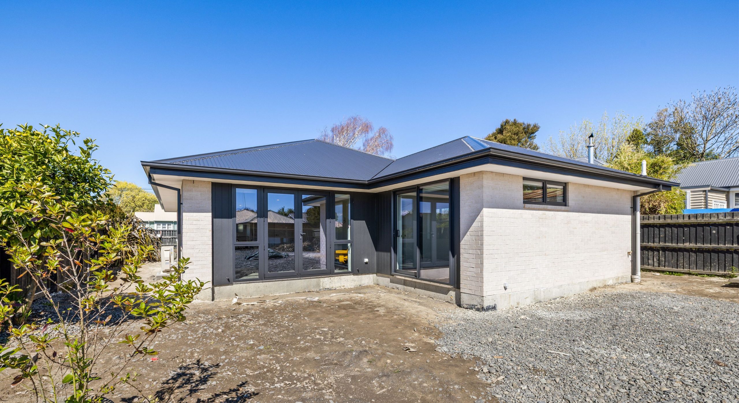 big dark window sliding doors and light plaster