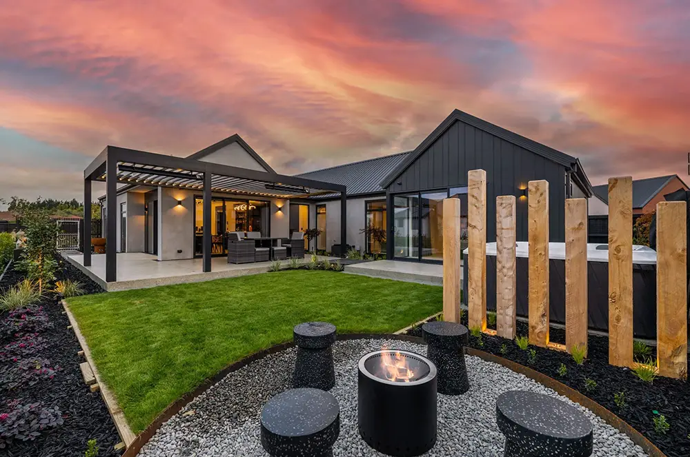 Hallmark Homes Oakbridge outdoor living area with pergola and alfresco dining at sunset - Christchurch custom home design and build