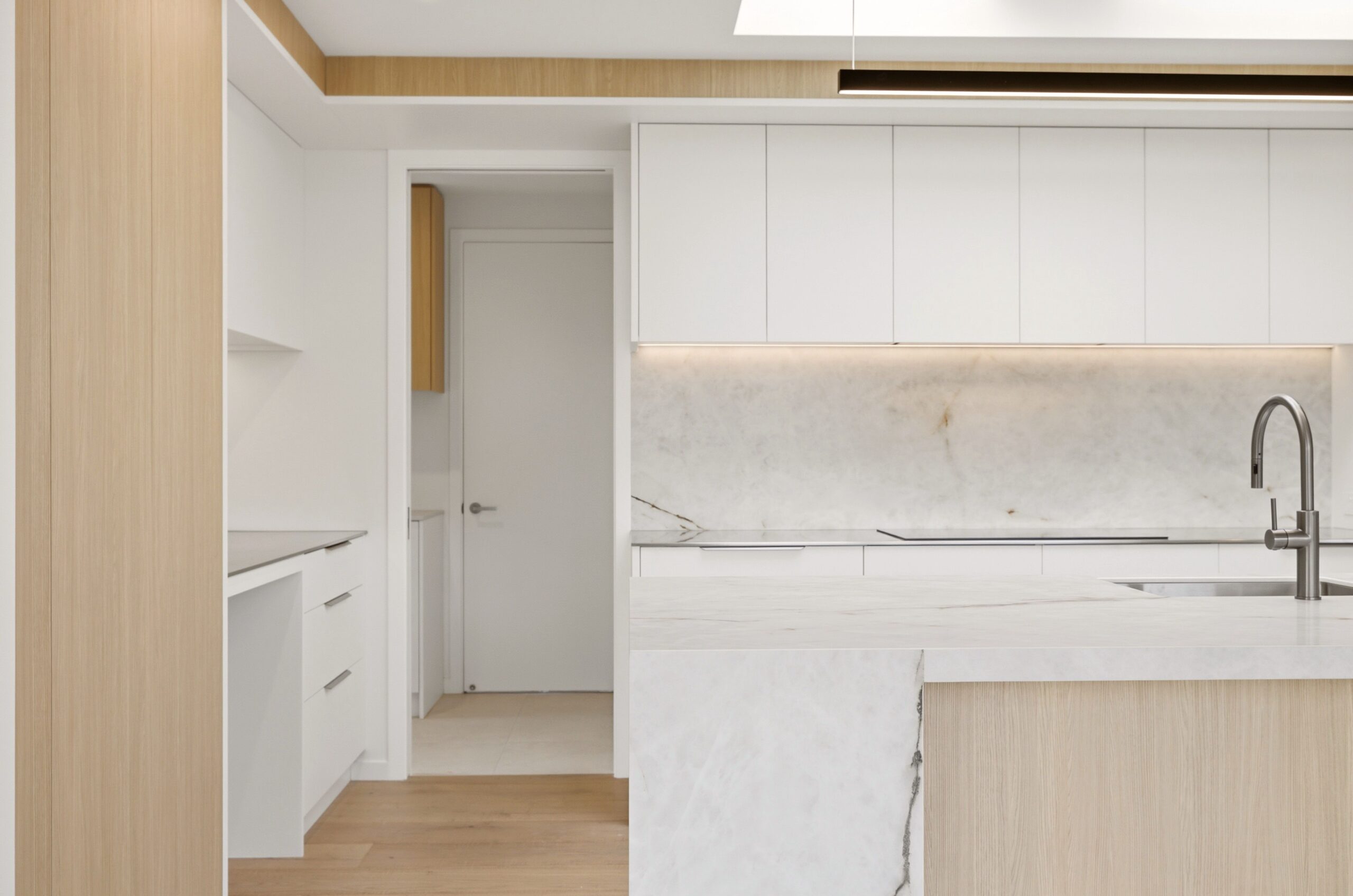 Wanaka plan, Hallmark Homes West Melton. Kitchen ceiling detail showing dual skylights and a linear pendant light above the island.