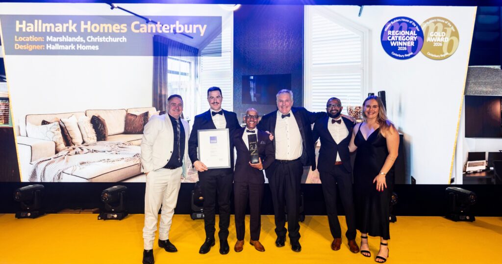 he Hallmark Homes Canterbury team on stage with the House of the Year Gold Award and Category Winner trophy for their Marshlands, Christchurch build