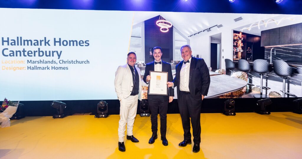 Paddy accepting the House of the Year Gold Award certificate for Hallmark Homes Canterbury's Marshlands, Christchurch build, alongside Mike and a colleague