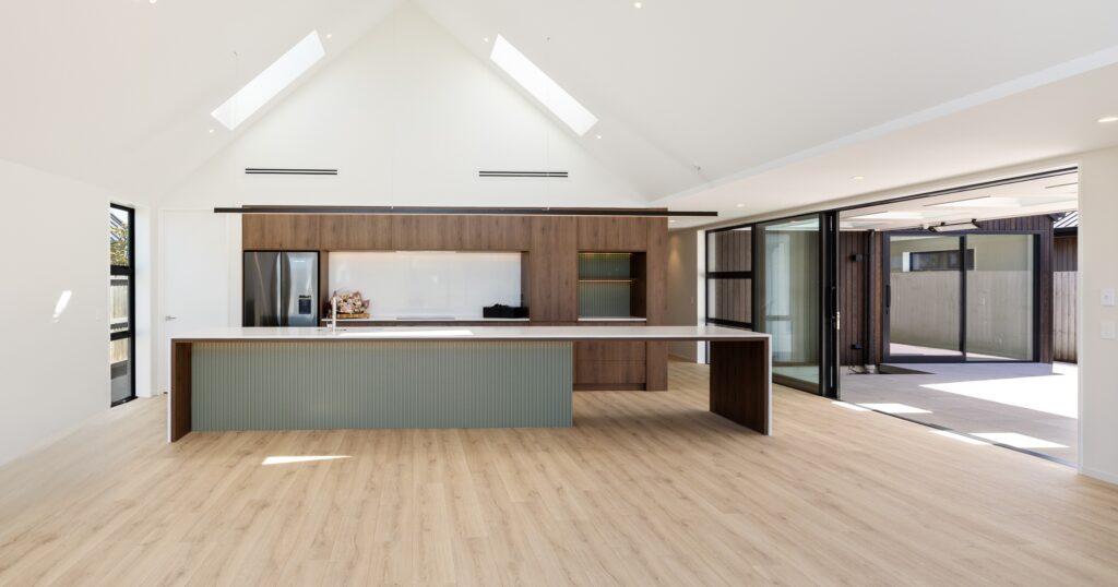 Large kitchen island bench designed for cooking and entertaining, a feature island trend in a Canterbury home