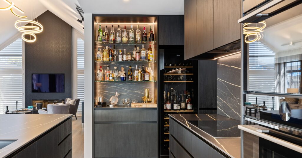 Full-height stone kitchen splashback with textured finish, a feature splashback trend in Canterbury kitchen design
